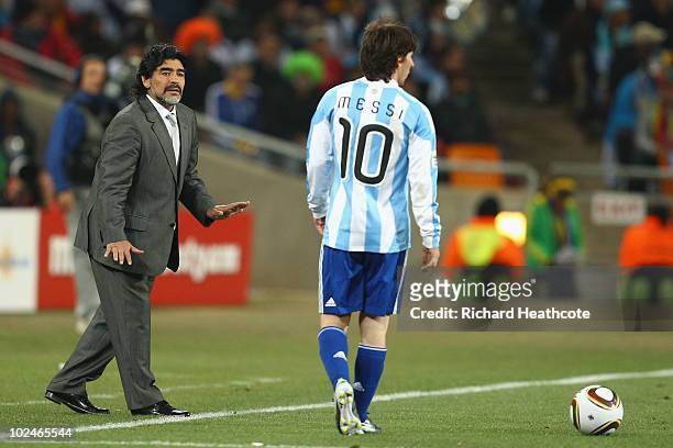 Diego Maradona head coach of Argentina gestures to Lionel Messi of Argentina during to the 2010 FIFA World Cup South Africa Round of Sixteen match...