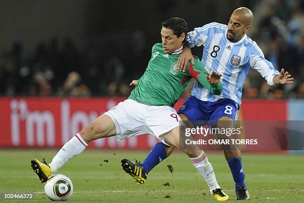 Mexico's striker Guillermo Franco is challenged for the ball by Argentina's midfielder Juan Sebastian Veron during the 2010 World Cup round of 16...
