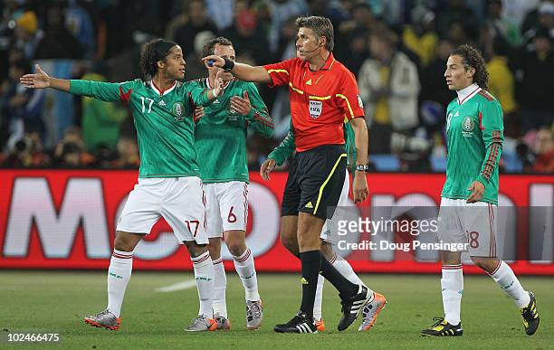 Mexico players complain to Referee Roberto Rosetti that the first Argentina goal was offside, during the 2010 FIFA World Cup South Africa Round of...