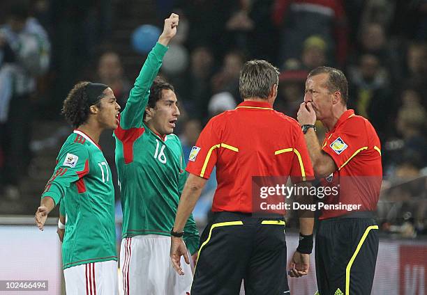 Mexico players complain to Referee Roberto Rosetti that the first Argentina goal was offside, during the 2010 FIFA World Cup South Africa Round of...