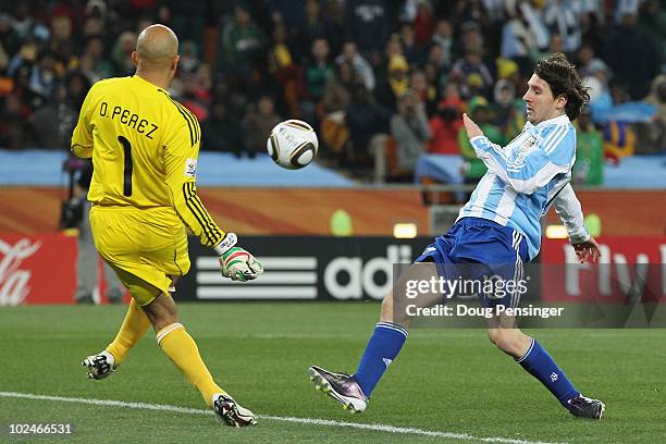 Oscar Perez of Mexico defends an attack from Lionel Messi of Argentina during the 2010 FIFA World Cup South Africa Round of Sixteen match between...