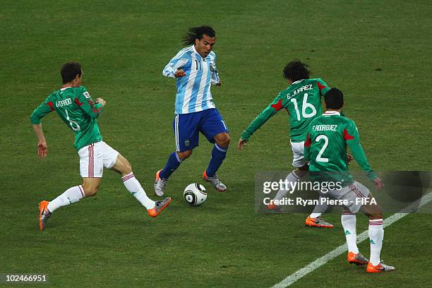 Carlos Tevez of Argentina is surrounded by Mexican defenders during the 2010 FIFA World Cup South Africa Round of Sixteen match between Argentina and...