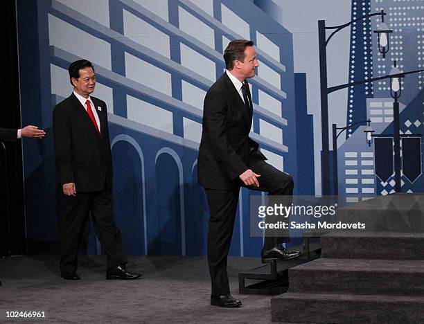 Britain's Prime Minister David Cameron and other world leaders arrive for a group photo during the G20 summit June 27, 2010 in Toronto, Ontario,...