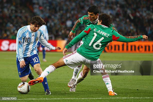 Efrain Juarez of Mexico tackles Lionel Messi of Argentina during the 2010 FIFA World Cup South Africa Round of Sixteen match between Argentina and...