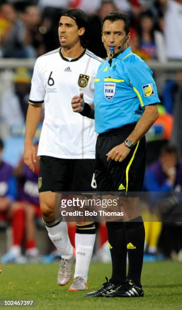 Referee Jorge Larrionda stands near Sami Khedira of Germany during the 2010 FIFA World Cup South Africa Round of Sixteen match between Germany and...