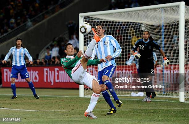 Pablo Barrera of Mexico kicks the ball overhead during the 2010 FIFA World Cup South Africa Round of Sixteen match between Argentina and Mexico at...