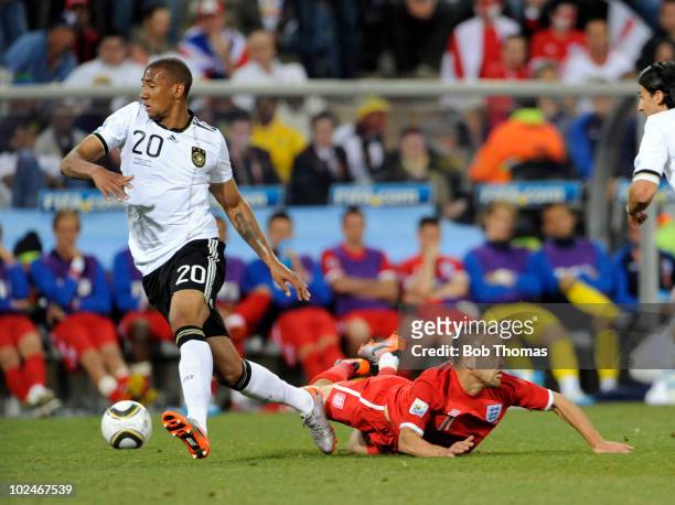 Jerome Boateng of Germany dribbles past Joe Cole of England during the 2010 FIFA World Cup South Africa Round of Sixteen match between Germany and...