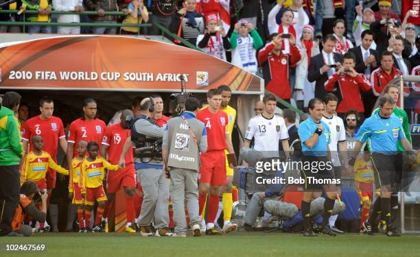 The England and German teams enter the stadium prior to the start of the 2010 FIFA World Cup South Africa Round of Sixteen match between Germany and...