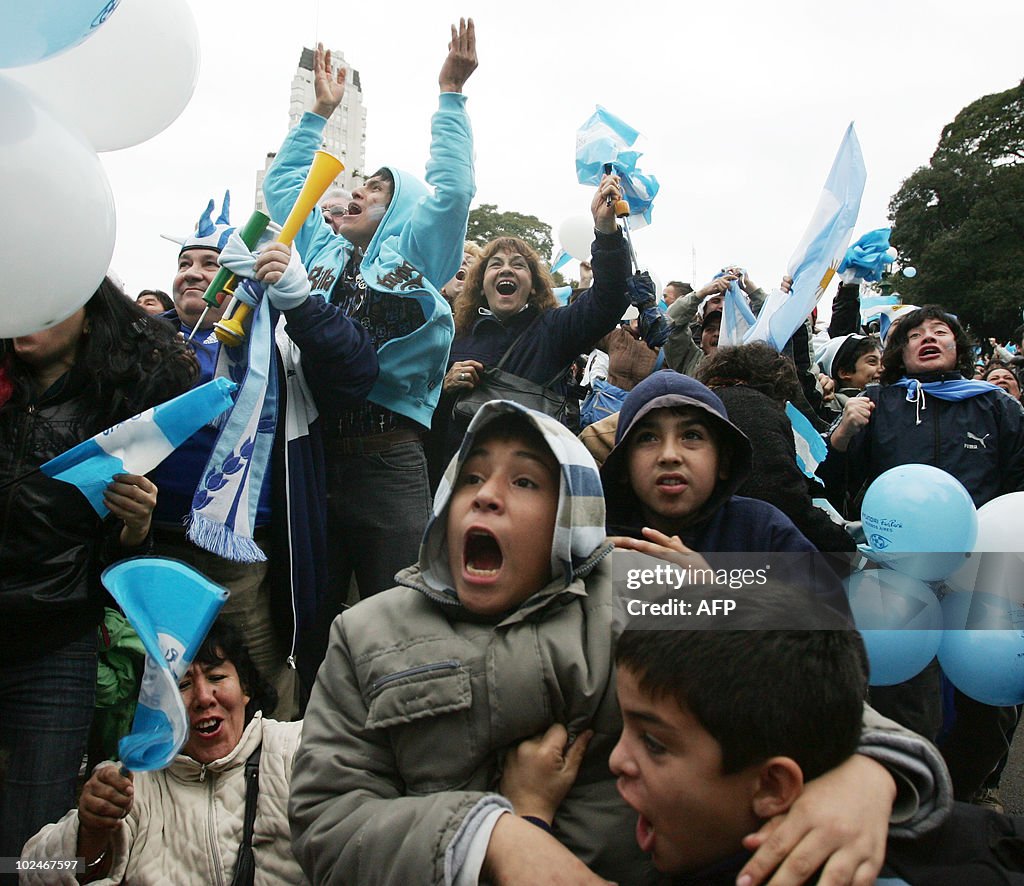 Argentine fans celebrate as they watch t