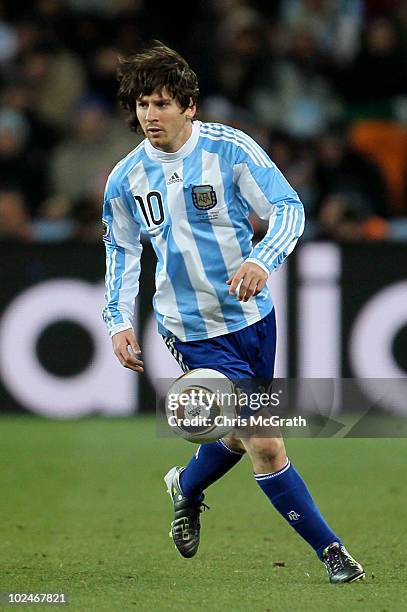 Lionel Messi of Argentina runs with the ball during the 2010 FIFA World Cup South Africa Round of Sixteen match between Argentina and Mexico at...