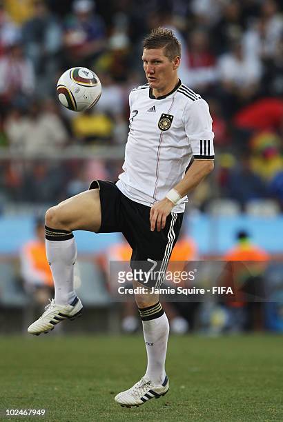 Bastian Schweinsteiger of Germany controls the ball during the 2010 FIFA World Cup South Africa Round of Sixteen match between Germany and England at...
