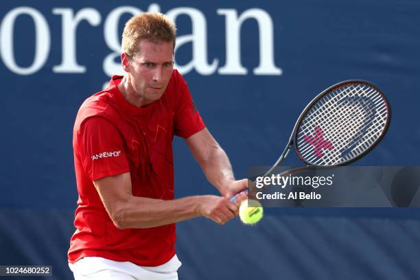 Florian Mayer of Germany returns the ball during his men's singles first round match against Borna Coric of Croatia on Day One of the 2018 US Open at...