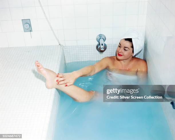 American swimmer and actress Esther Williams in a bath, circa 1950.