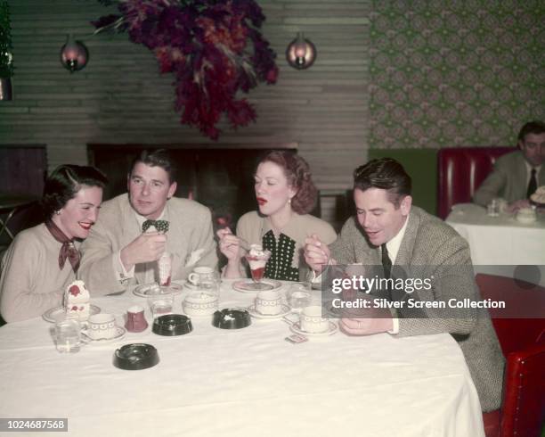 American actor Ronald Reagan and his second wife, actress Nancy Davis , eating ice cream sundaes with actors Eleanor Powell and her husband, actor...