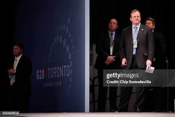 White House Press Secretary Robert Gibbs watches as U.S. President Barack Obama holds a press conference at the conclusion of the G20 Summit June 27,...