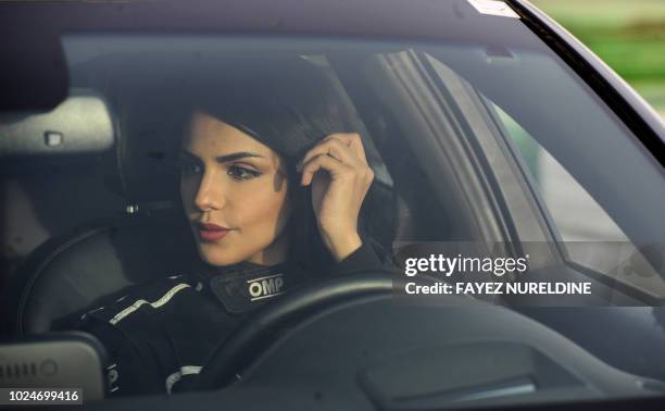 Rana Almimoni, a 30-year-old Saudi motor racing enthusiast, sits in her car on a track in Dirab motor park, on the southern outskirts of the capital...