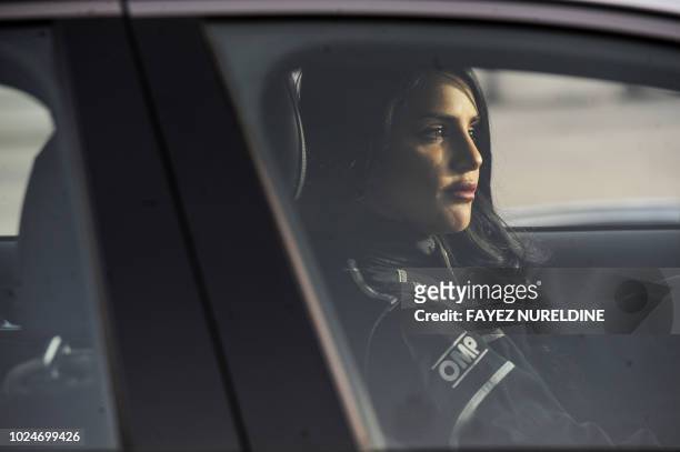 Rana Almimoni, a 30-year-old Saudi motor racing enthusiast, sits in her car on a track in Dirab motor park, on the southern outskirts of the capital...