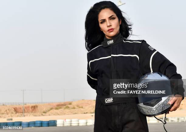 Rana Almimoni, a 30-year-old Saudi motor racing enthusiast, poses with her helmet on the track in Dirab motor park, on the southern outskirts of the...