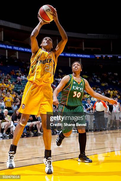 Tanisha Wright of the Seattle Storm watches as Marion Jones of the Tulsa Shock puts away a last minute shot at the end of the half during the WNBA...