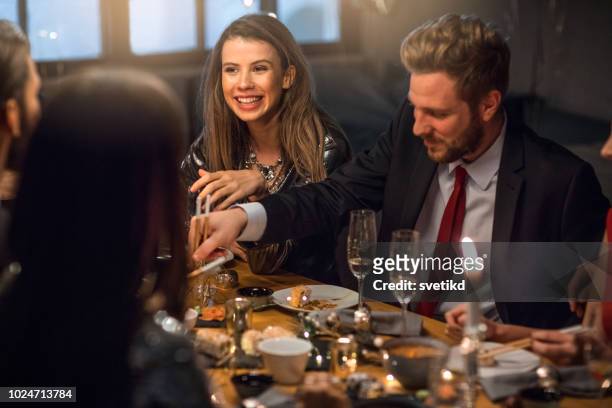 new year dinner party - glamour couple stock pictures, royalty-free photos & images
