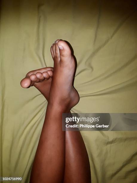 feet of a 8-year old boy lying on a bed - feet in bed stock pictures, royalty-free photos & images