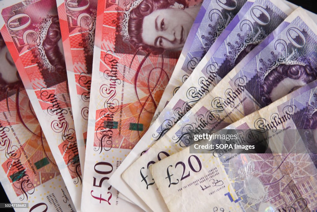 Fifty pounds bank notes are seen in this photo illustration...