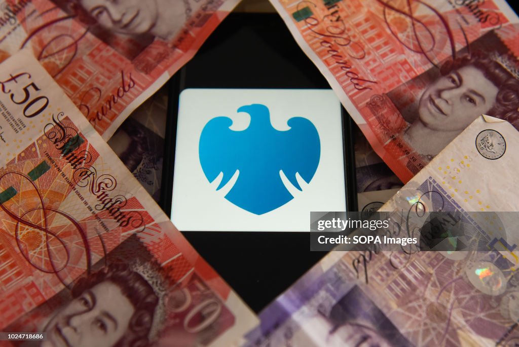 Fifty and twenty pounds bank notes and Barclays bank logo...