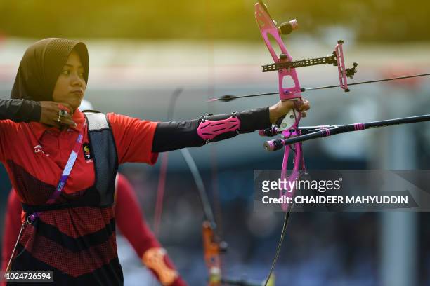 Indonesia's Diananda Choirunisa competes in the archery recurve women's individual final round against China's Zhang Xinyan at the 2018 Asian Games...