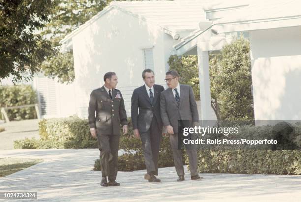 President of the United States Richard Nixon pictured in centre with National Security Advisor Henry Kissinger and Alexander Haig , Vice Chief of...