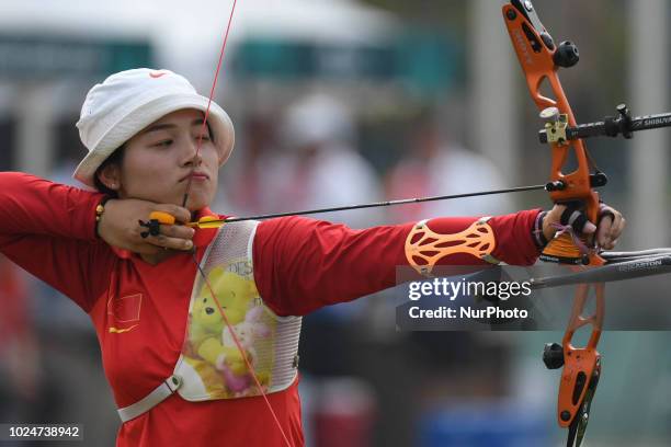 China's Zhang Xinyan in action on the Archery Recurve Women's Individual Final Asian Games 18th against Indonesia's Choirunisa Diananda at Archery...