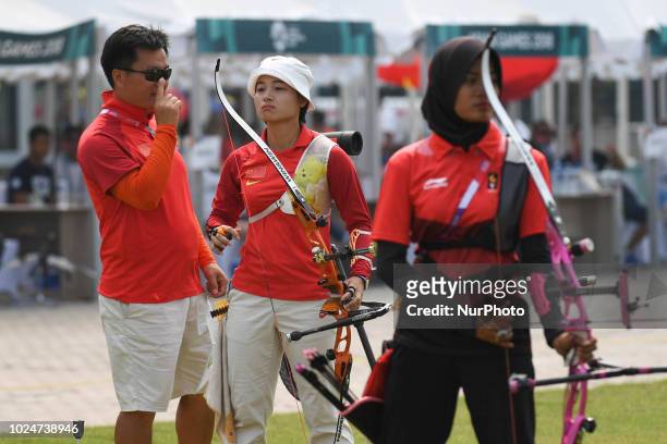 China's Zhang Xinyan with his coach during the Archery Recurve Women's Individual Final Asian Games 18th against Indonesia's Choirunisa Diananda at...
