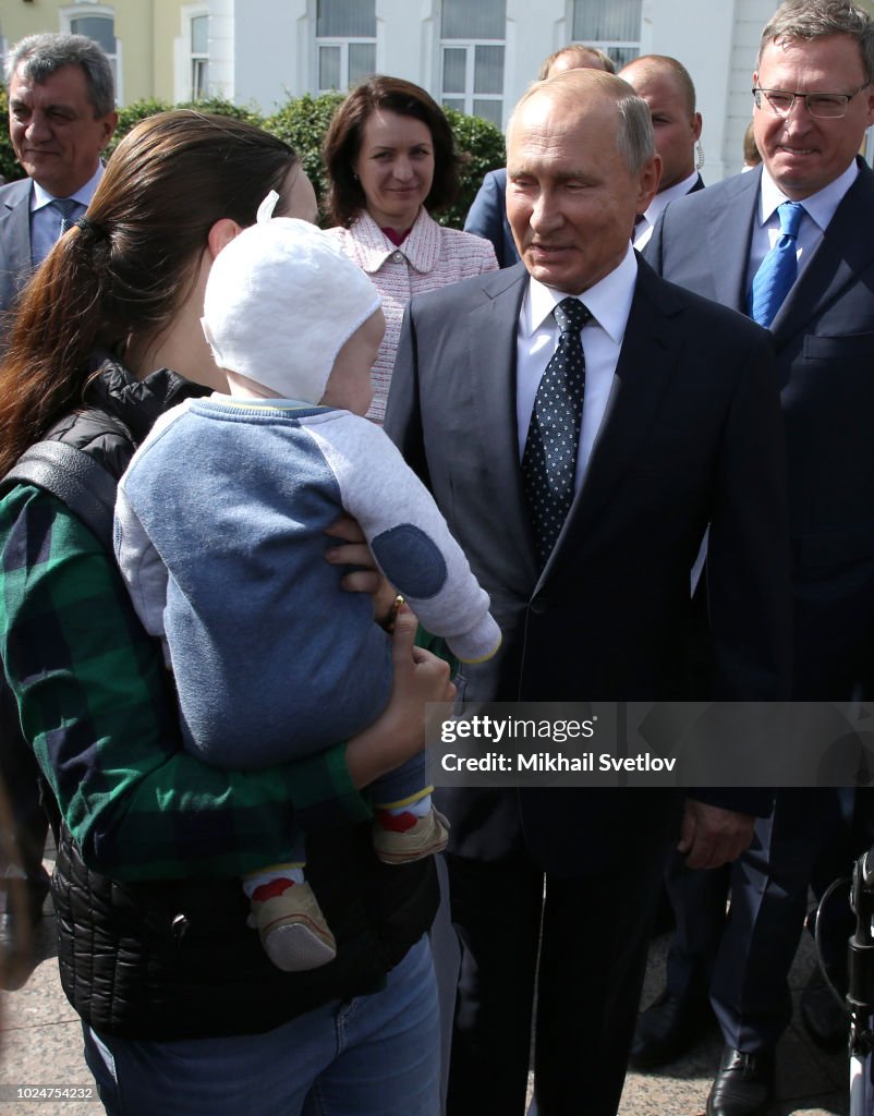 Russian President Vladimir Putin speaks with local residents on the ...
