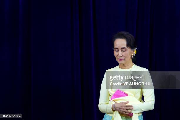Myanmar State Counsellor Aung San Suu Kyi leaves after delivering address before students of Yangon University general assembly in Yangon on August...