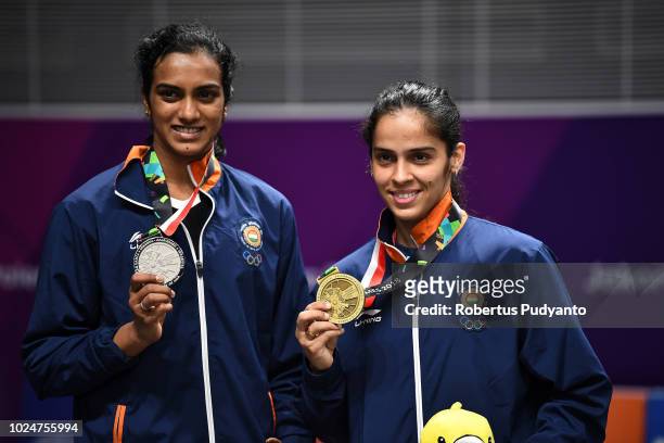 Silver medalist Pusarla V. Sindhu of India and bronze medalist Saina Nehwal of India celebrate on the podium during Women's Singles medals ceremony...