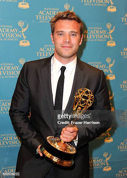 Actor Billy Miller poses with the Outstanding Supporting Actor Award in the press room at the 37th Annual Daytime Entertainment Emmy Awards held at...