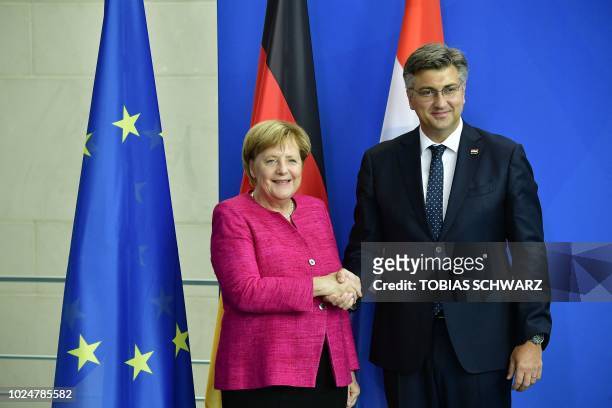German Chancellor Angela Merkel and Croatian Prime Minister Andrej Plenkovic shake hands after a joint press conference in Berlin on August 28, 2018.