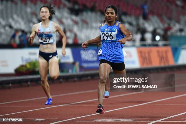 India's Dutee Chand competes in a semi-final heat of the women's 200m athletics event during the 2018 Asian Games in Jakarta on August 28, 2018.