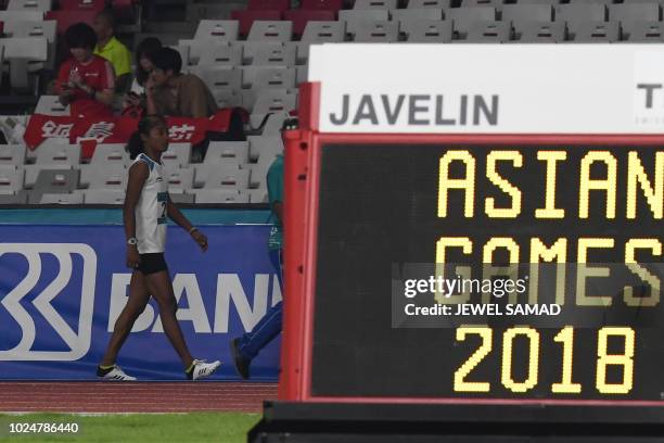 India's Hima Das walks from the track during the semi-final heats of the women's 200m athletics event during the 2018 Asian Games in Jakarta on...