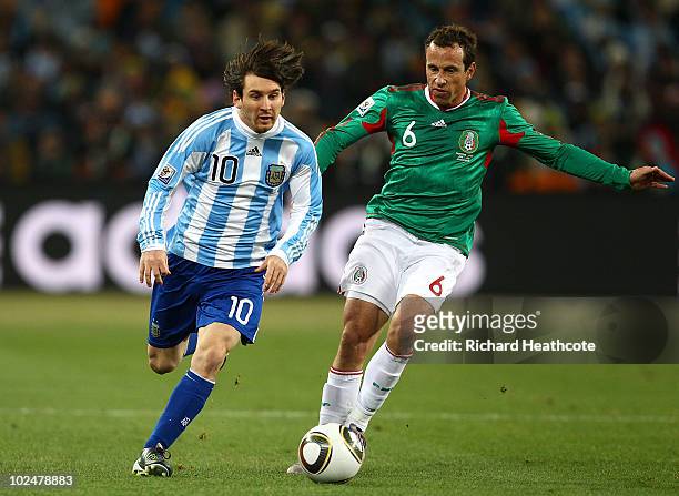 Lionel Messi of Argentina goes past Gerardo Torrado of Mexico during the 2010 FIFA World Cup South Africa Round of Sixteen match between Argentina...