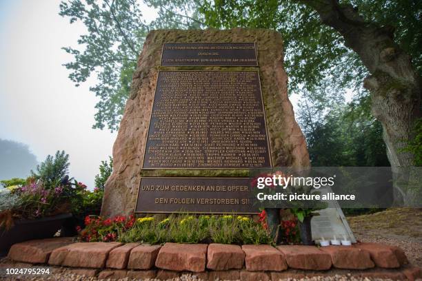 August 2018, Germany, Ramstein-Miesenbach: The memorial stone with the names of the victims of the catastrophe of the air show at Ramstein Airbase is...