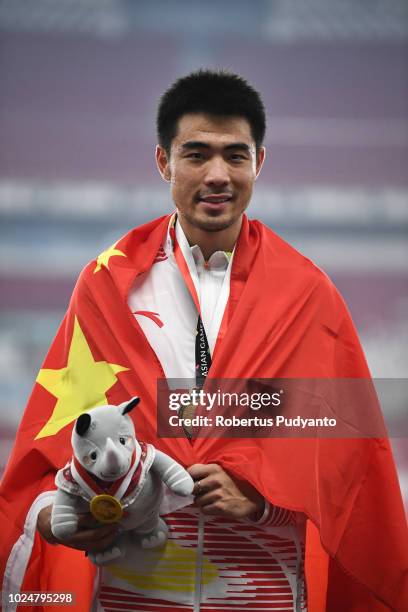 Gold medalist Xie Wenjun of China celebrates on the podium during Men's 110m Hurdles victory ceremony on day ten of the Asian Games on August 28,...