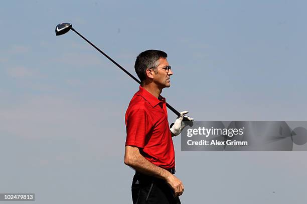 Herbert Hainer, CEO of German sportswear and equipment group Adidas, follows the ball after teeing off at the TaylorMade-adidas Golf Pro-Am...