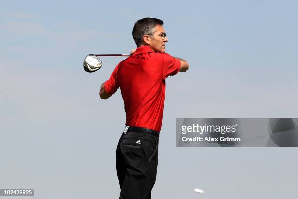 Herbert Hainer, CEO of German sportswear and equipment group Adidas, follows the ball after teeing off at the TaylorMade-adidas Golf Pro-Am...