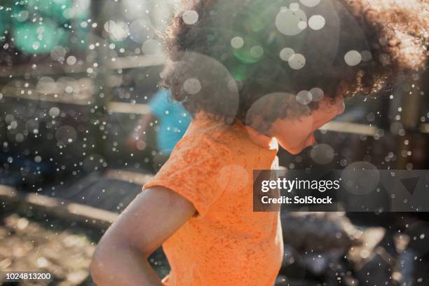 little boy having fun in the sprinklers - rain garden stock pictures, royalty-free photos & images