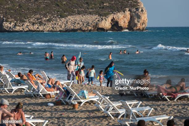 One 21 August women wearing burkinis walk on the sandy Patara Beach, a popular tourist destination on the Mediterranean coast in Antalya, Turkey,...