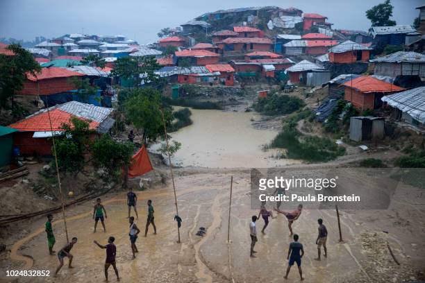 Monsoon rains hit the refugee camps as Rohingya play Sepak Takraw August 28, 2018 in Balukhali refugee camp, Cox's Bazar, Bangladesh. UN...