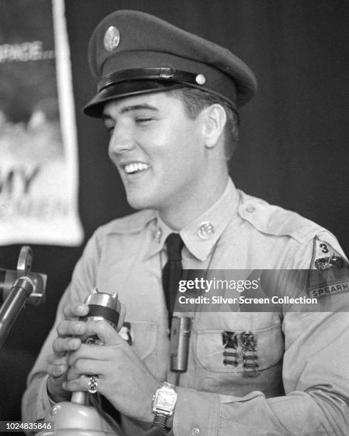 American singer and actor Elvis Presley addresses a press conference at the New York Port of Embarkation's Brooklyn Army Terminal , New York City, as...