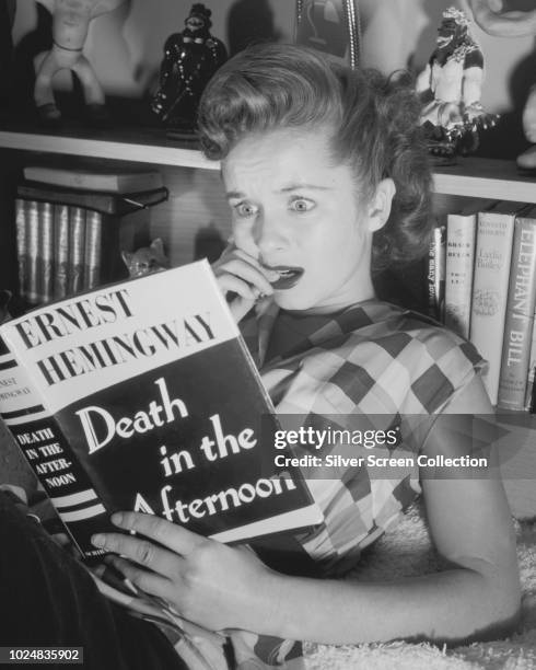 American actress and singer Debbie Reynolds reads Ernest Hemingway's book 'Death in the Afternoon', circa 1950.