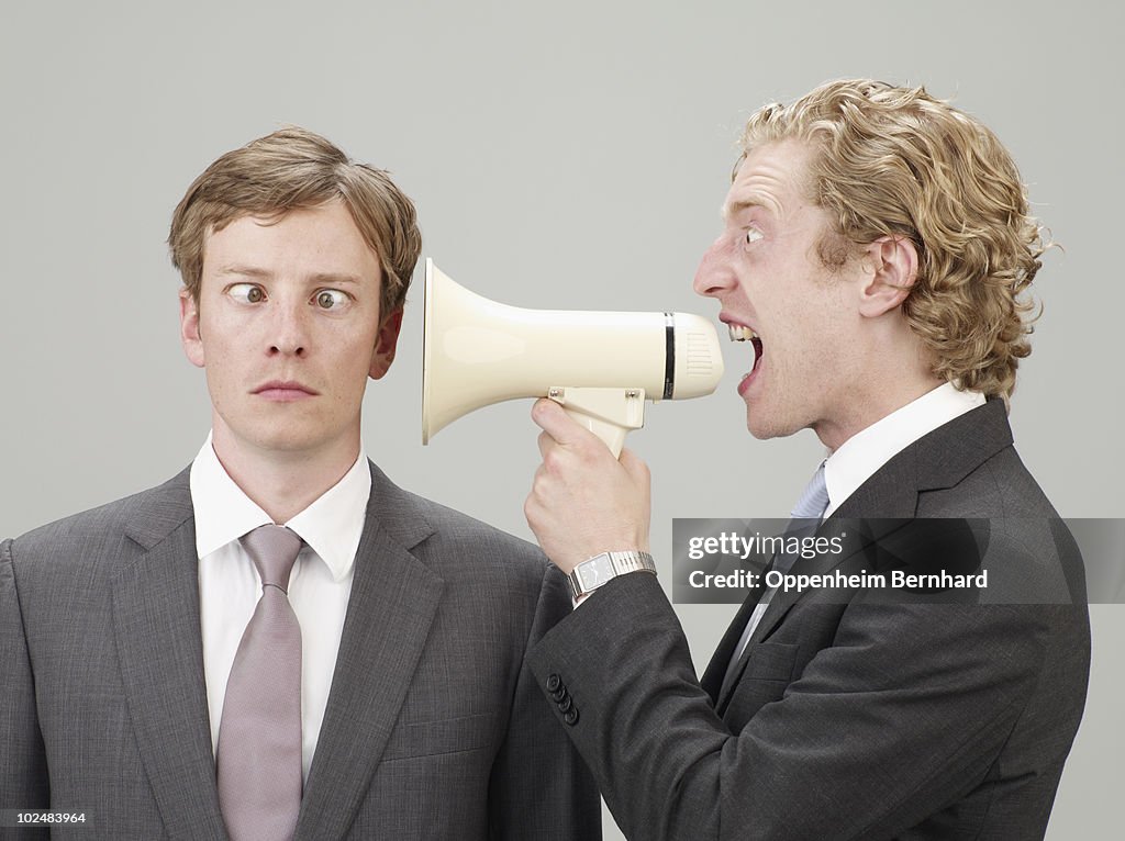 Shouting through megaphone at another man