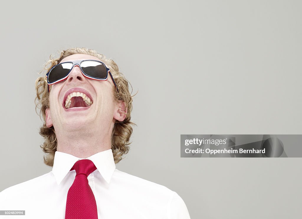 Businessman in glasses laughing